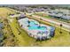 Aerial view of the community pool with lounge chairs and sunshades in a well-maintained, fenced-in area at 4965 Kaia Ave, Winter Haven, FL 33884