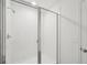 A sleek, modern shower with a clear glass door and white tiled walls is featured at 4965 Kaia Ave, Winter Haven, FL 33884