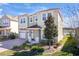 Charming two-story home features lush landscaping, a brick driveway, and an attached garage at 5080 Longmeadow Park St, Orlando, FL 32811