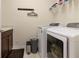 This efficient laundry room has a washer, dryer, and counter space for folding, plus convenient storage at 5080 Longmeadow Park St, Orlando, FL 32811