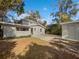 Backyard showcasing a spacious paved area and a detached garage, offering ample outdoor space at 662 Lake Dr, Altamonte Springs, FL 32701