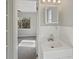 A partial bathroom view features a sink and a view into the sunlit bedroom beyond at 662 Lake Dr, Altamonte Springs, FL 32701