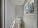 Small bathroom features toilet, window, and wood-look floors at 662 Lake Dr, Altamonte Springs, FL 32701