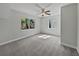 A bright bedroom features plush carpeting, a ceiling fan, and two windows offering natural light at 662 Lake Dr, Altamonte Springs, FL 32701