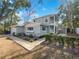 Charming two-story home with a well-manicured lawn, inviting walkway, and mature trees on a sunny day at 662 Lake Dr, Altamonte Springs, FL 32701