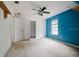 The bedroom features a ceiling fan, closet, and a brightly painted wall at 6801 County Rd 665, Bushnell, FL 33513