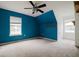 The bedroom features a ceiling fan and brightly painted walls at 6801 County Rd 665, Bushnell, FL 33513