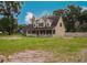 Charming two-story home with a welcoming front porch and a spacious front yard, perfect for outdoor activities at 6801 County Rd 665, Bushnell, FL 33513