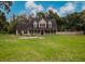 Charming two-story home with a welcoming front porch and a spacious front yard, perfect for outdoor activities at 6801 County Rd 665, Bushnell, FL 33513