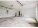 Spacious two car garage with white walls and ceiling mounted storage racks at 6801 County Rd 665, Bushnell, FL 33513