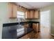 The kitchen features wood cabinetry, dark countertops and modern faucet at 6801 County Rd 665, Bushnell, FL 33513