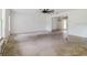 Large living room with high ceilings, large windows, and a unique ceiling fan at 6801 County Rd 665, Bushnell, FL 33513