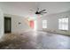 Large living room with high ceilings, large windows, and a unique ceiling fan at 6801 County Rd 665, Bushnell, FL 33513