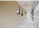 Covered porch featuring a concrete floor, exterior lighting, and ceiling fans at 6801 County Rd 665, Bushnell, FL 33513
