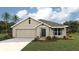 Charming single-story home with a two-car garage, simple landscaping and a neatly manicured lawn at 6989 Sw 135Th Pl, Ocala, FL 34473