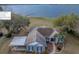Lakefront property featuring a long dock, covered boat parking, and beautifully maintained landscaping at 9130 Laws Rd, Clermont, FL 34714