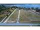 Aerial view of a large, partially cleared lot with a long driveway, ready for building your dream home at 9130 Laws Rd, Clermont, FL 34714