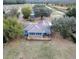 Sprawling property with a house featuring a large deck, surrounded by trees and expansive lawn areas at 9130 Laws Rd, Clermont, FL 34714