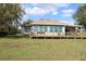Rear view of home, showcasing a large deck and backyard, perfect for outdoor entertaining at 9130 Laws Rd, Clermont, FL 34714