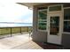 Charming back porch providing stunning lake views through clear glass door and windows at 9130 Laws Rd, Clermont, FL 34714