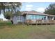 Back porch view with wooden railing and lawn in the background at 9130 Laws Rd, Clermont, FL 34714