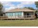 Back porch with wooden railing and lawn in the background at 9130 Laws Rd, Clermont, FL 34714