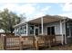 Inviting back porch with wood decking, covered patio and a view of the beautiful landscape at 9130 Laws Rd, Clermont, FL 34714