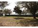 Spacious backyard with mature trees and a view of the lake, offering a peaceful outdoor retreat at 9130 Laws Rd, Clermont, FL 34714