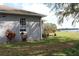 Side view of home, featuring a deck and a glimpse of the lake, highlighting the property's serene setting at 9130 Laws Rd, Clermont, FL 34714
