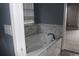 Relaxing bathroom showcasing a luxurious white bathtub with elegant marble surround and modern fixtures at 9130 Laws Rd, Clermont, FL 34714