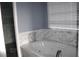 Bathroom featuring a modern tub, and tiled walls at 9130 Laws Rd, Clermont, FL 34714
