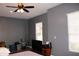 Bedroom featuring hardwood floors, windows with blinds, ceiling fan, and neutral gray paint at 9130 Laws Rd, Clermont, FL 34714