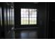 Bedroom with hardwood floors, dark gray walls and view of waterfront from window at 9130 Laws Rd, Clermont, FL 34714