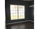 Bedroom featuring hardwood floors, paint in neutral gray, and a large window for natural light at 9130 Laws Rd, Clermont, FL 34714