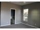 Cozy bedroom featuring neutral walls, carpet floors, and a bright window for natural light at 9130 Laws Rd, Clermont, FL 34714
