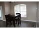 Cozy dining area with a dark wood table and chairs set by a bright window at 9130 Laws Rd, Clermont, FL 34714