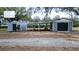 Exterior view showing 2 sheds with a shared carport; lots of covered storage! at 9130 Laws Rd, Clermont, FL 34714