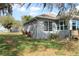 Backyard view of a gray house with white trim and a spacious yard at 9130 Laws Rd, Clermont, FL 34714