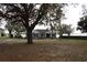 Charming single-story home with a well-manicured lawn and mature trees at 9130 Laws Rd, Clermont, FL 34714