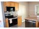 Kitchen with stainless steel oven and dishwasher, granite countertops, and wooden cabinets at 9130 Laws Rd, Clermont, FL 34714