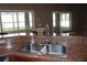 Stainless steel kitchen sink featuring a brushed silver faucet and granite countertops at 9130 Laws Rd, Clermont, FL 34714