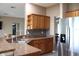 Kitchen showcasing granite countertops, stainless steel appliances, and wood cabinetry at 9130 Laws Rd, Clermont, FL 34714