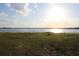 Scenic lake view with calm waters under a bright, sunny sky at 9130 Laws Rd, Clermont, FL 34714