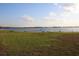 Expansive lake view with a distant wooden dock, perfect for recreation at 9130 Laws Rd, Clermont, FL 34714