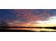 Picturesque lake view at sunset reflecting pink and purple skies, creating a serene landscape at 9130 Laws Rd, Clermont, FL 34714