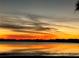 Sunset reflecting over still lake waters at 9130 Laws Rd, Clermont, FL 34714