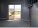 Living room featuring a sliding door with access to the deck overlooking the lake at 9130 Laws Rd, Clermont, FL 34714