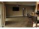 Open-concept living room with bar seating, wood flooring, and large sliding glass doors at 9130 Laws Rd, Clermont, FL 34714