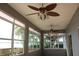 Enclosed sun room featuring multiple windows providing plenty of natural light and ceiling fans at 9130 Laws Rd, Clermont, FL 34714