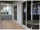 Bright sun room with tiled floor, providing beautiful views of the lake through sliding glass doors at 9130 Laws Rd, Clermont, FL 34714